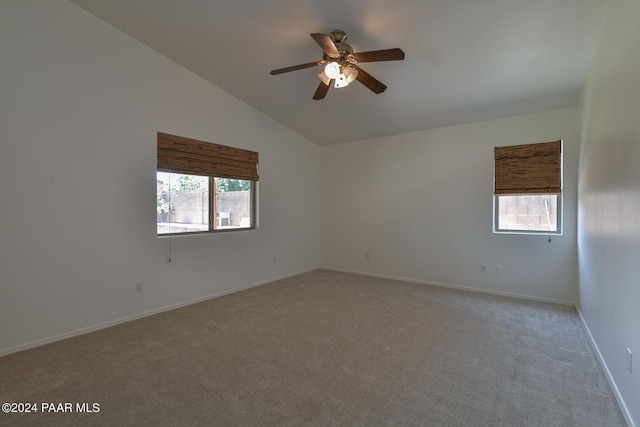 unfurnished room featuring light colored carpet, ceiling fan, and lofted ceiling