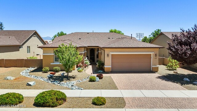 1147 N Lucky Draw Dr, Prescott Valley, AZ 86314 - view of front of property featuring an attached garage, decorative driveway, and stucco siding