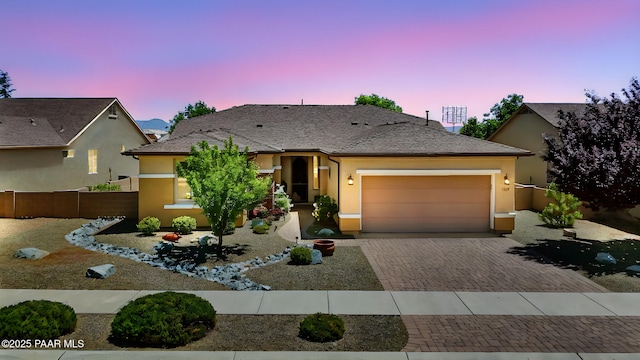 1147 N Lucky Draw Dr, Prescott Valley, AZ 86314 - view of front of home with decorative driveway, a garage, and stucco siding