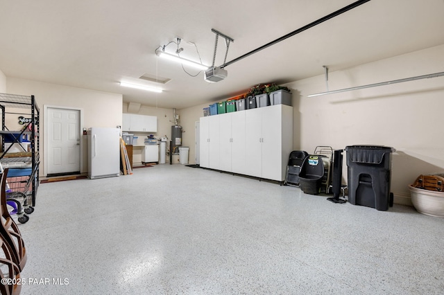 1147 N Lucky Draw Dr, Prescott Valley, AZ 86314 - garage featuring freestanding refrigerator, a garage door opener, and water heater