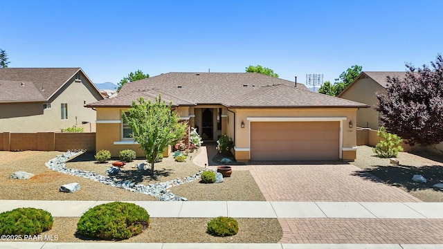 1147 N Lucky Draw Dr, Prescott Valley, AZ 86314 - view of front of property featuring an attached garage, decorative driveway, and stucco siding