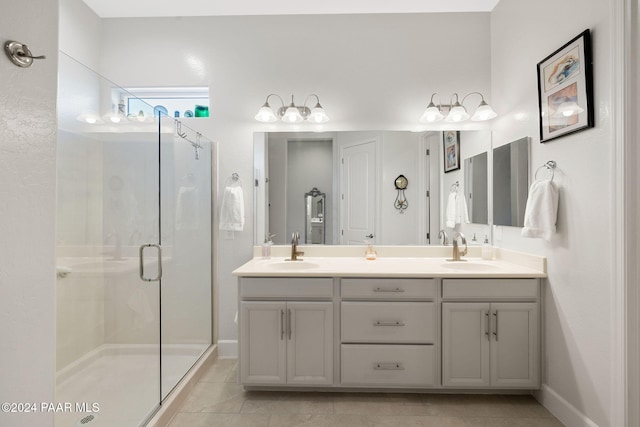 bathroom with vanity, an enclosed shower, and tile patterned floors