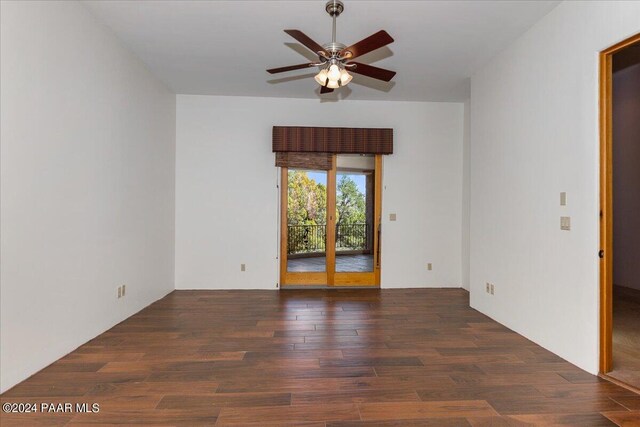 unfurnished room featuring ceiling fan and dark hardwood / wood-style flooring