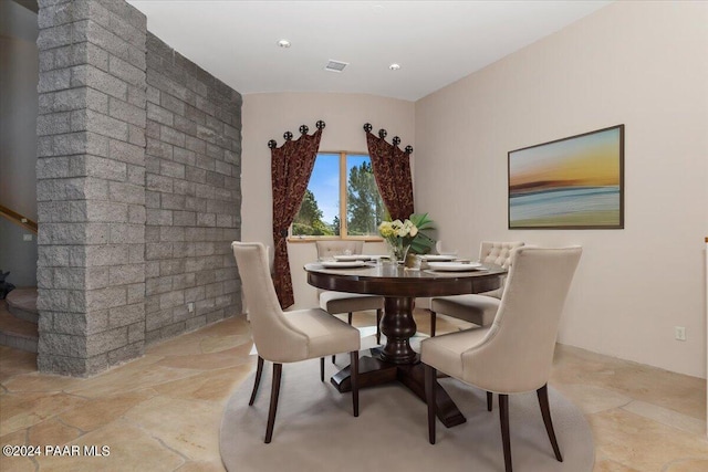 dining space featuring visible vents and stone tile floors