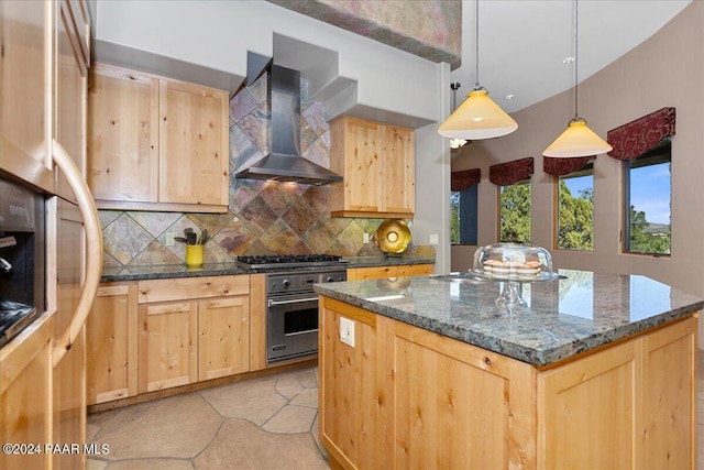 kitchen with light brown cabinetry, appliances with stainless steel finishes, wall chimney exhaust hood, and decorative backsplash