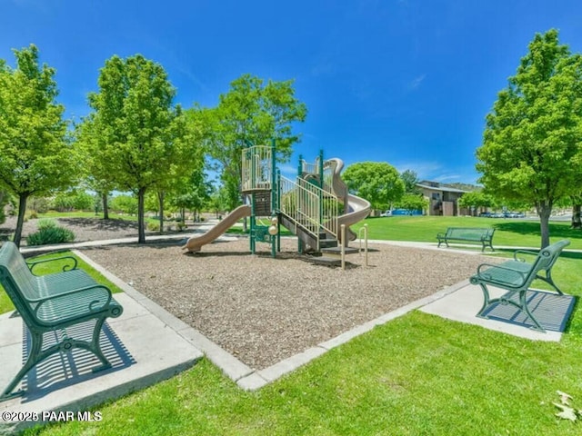 view of playground with a lawn