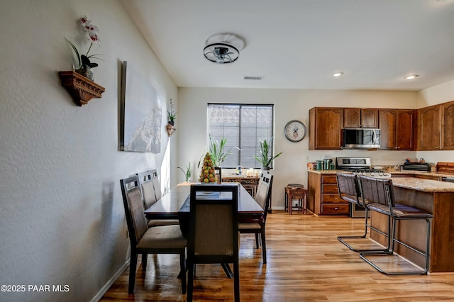 dining room with light wood-type flooring