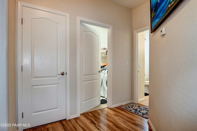 hall with washer / clothes dryer and hardwood / wood-style floors