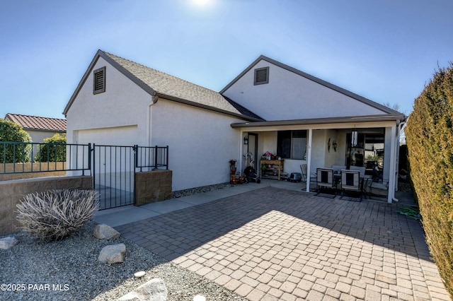 back of property with a garage and a porch