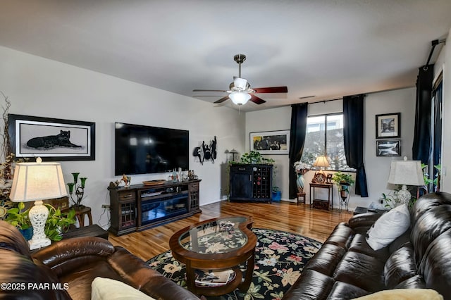 living room featuring ceiling fan and hardwood / wood-style floors