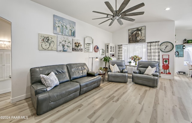 living room with ceiling fan, lofted ceiling, and light hardwood / wood-style flooring