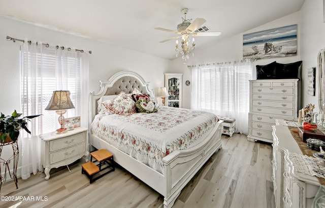 bedroom with vaulted ceiling, light hardwood / wood-style flooring, multiple windows, and ceiling fan