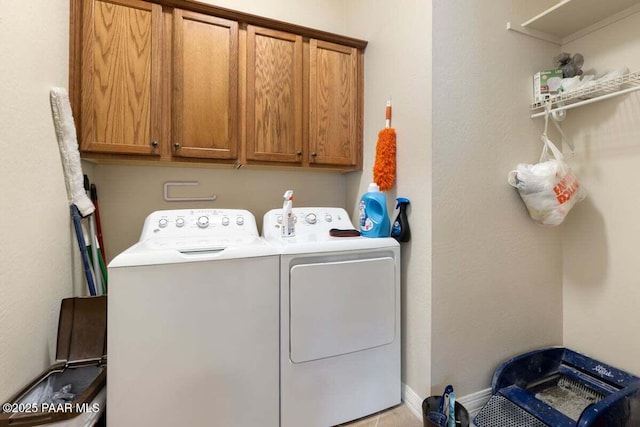 laundry room with cabinets and washing machine and clothes dryer