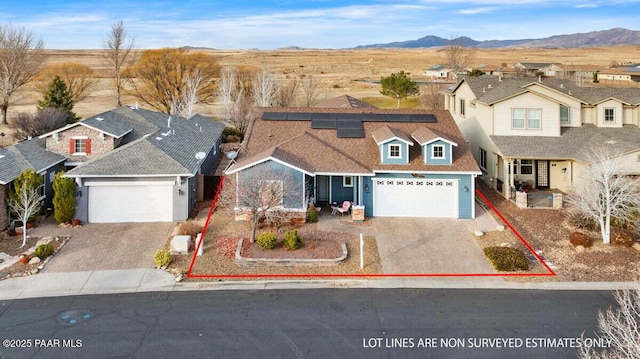 view of front of home featuring a mountain view and solar panels