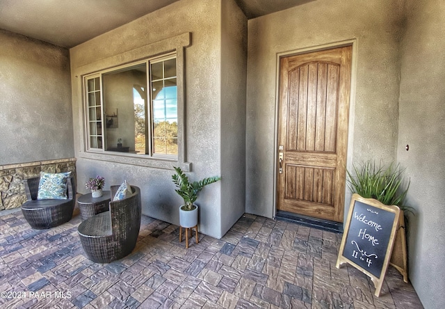 property entrance with stucco siding