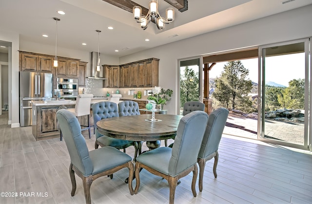 dining space with visible vents, light wood-type flooring, a notable chandelier, and recessed lighting