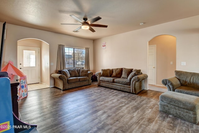 living room with ceiling fan and wood-type flooring