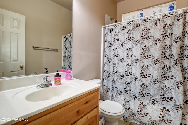 bathroom featuring vanity, a shower with shower curtain, and toilet