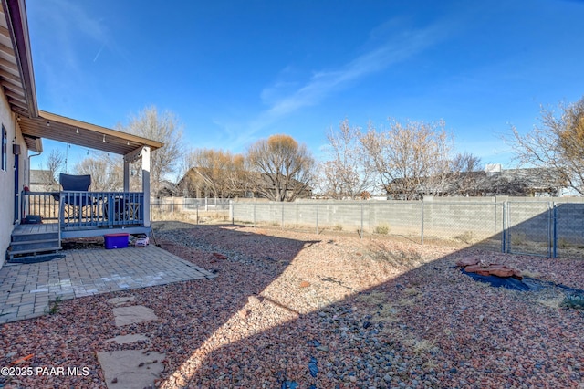 view of yard with a patio area and a wooden deck