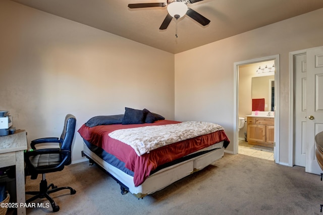 bedroom featuring light carpet, connected bathroom, and ceiling fan