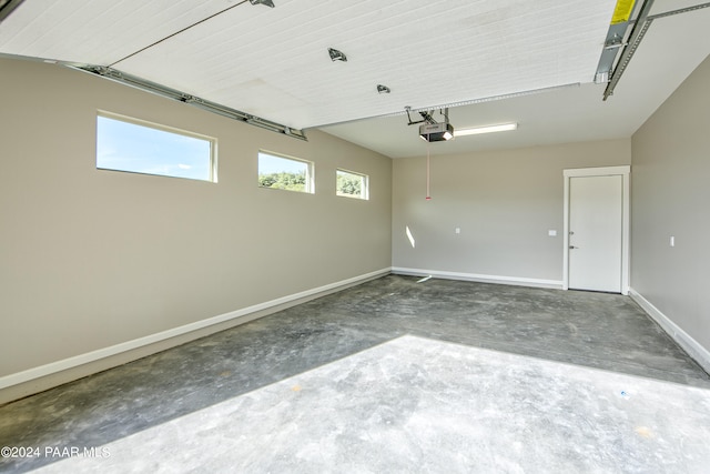garage featuring baseboards and a garage door opener