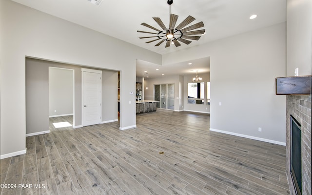 unfurnished living room with recessed lighting, light wood-style floors, baseboards, and a fireplace