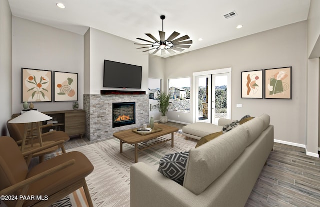 living room featuring visible vents, wood finished floors, a fireplace, baseboards, and recessed lighting