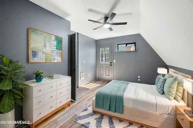 bedroom featuring vaulted ceiling, light hardwood / wood-style floors, and ceiling fan