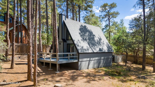 rear view of property featuring a deck