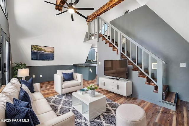 living room featuring hardwood / wood-style floors and a high ceiling