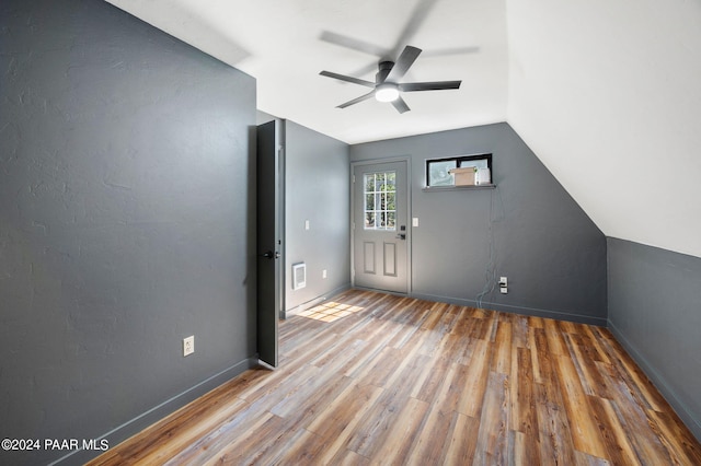 additional living space featuring lofted ceiling, hardwood / wood-style floors, and ceiling fan