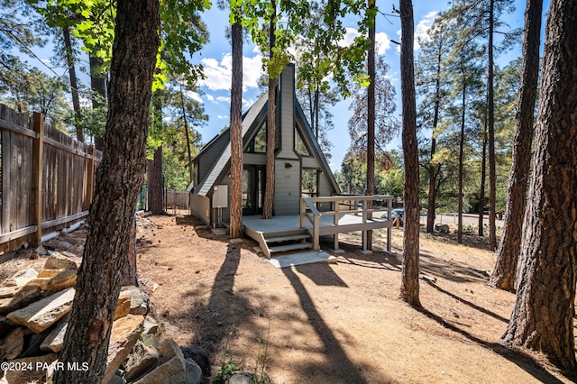 back of property featuring a wooden deck