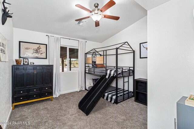 bedroom with ceiling fan, carpet floors, and vaulted ceiling