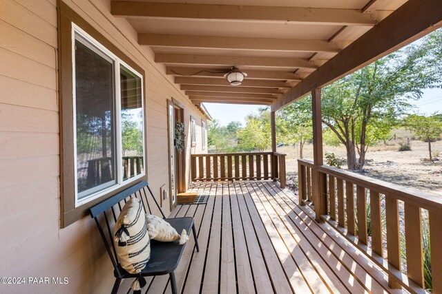 wooden deck featuring ceiling fan