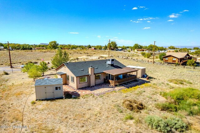 back of property featuring a storage unit