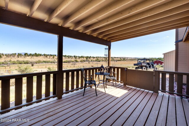 wooden deck featuring a rural view