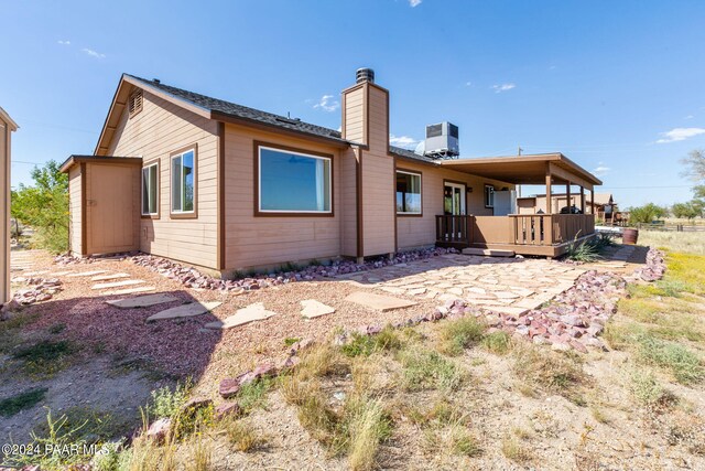 back of property with a patio area and central air condition unit