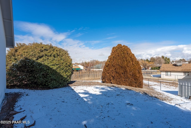 view of yard layered in snow