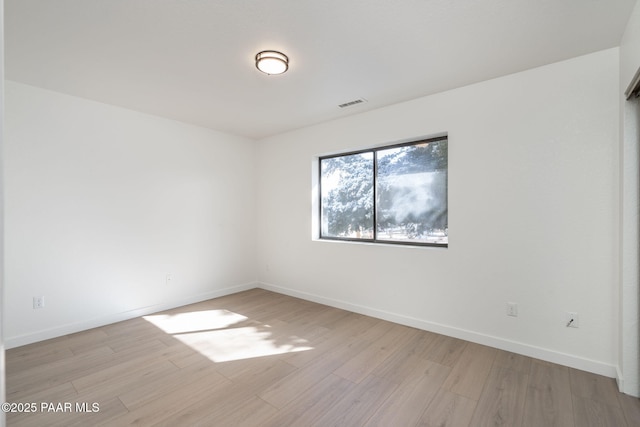 unfurnished room with light hardwood / wood-style floors