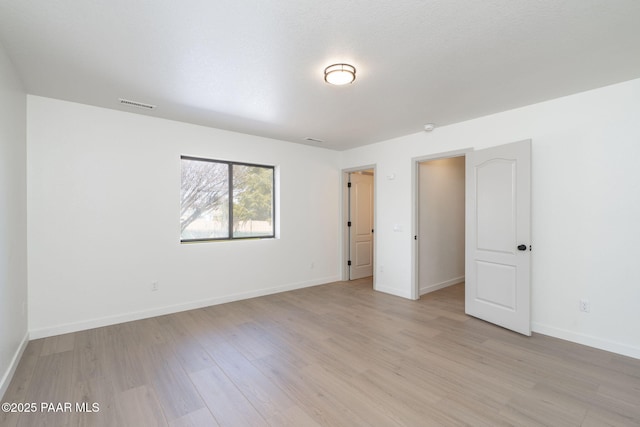 spare room featuring light hardwood / wood-style flooring