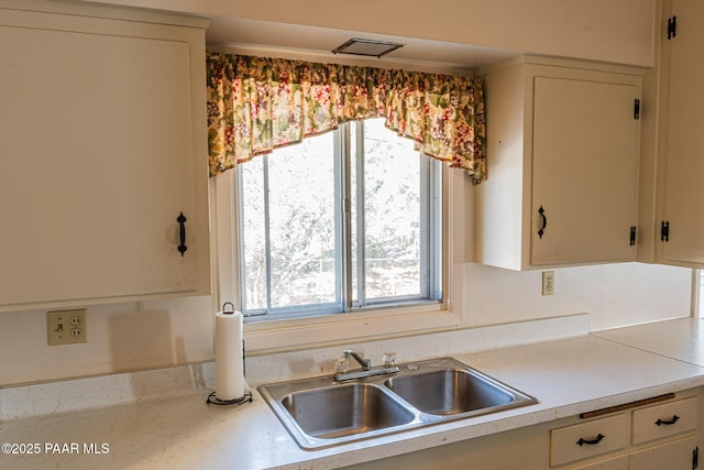 kitchen with light countertops and a sink