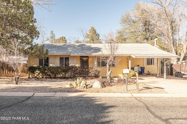 single story home featuring fence and driveway