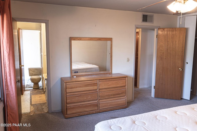 carpeted bedroom featuring visible vents