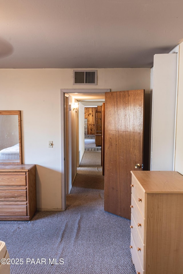 hallway with visible vents and carpet floors