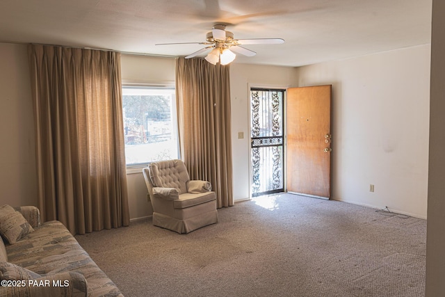 sitting room featuring ceiling fan and carpet flooring