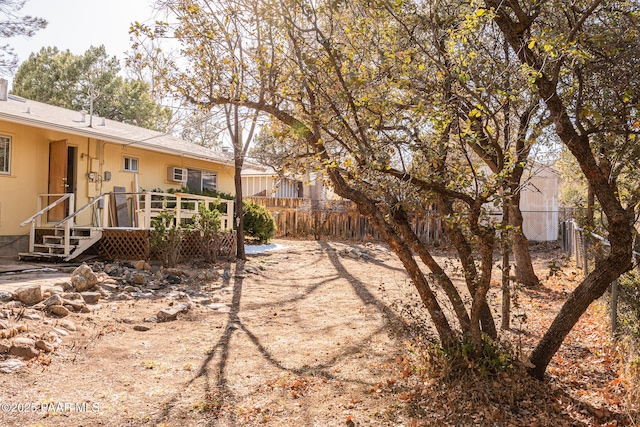 view of yard with a wooden deck and fence