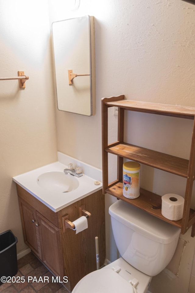 half bathroom with toilet and vanity