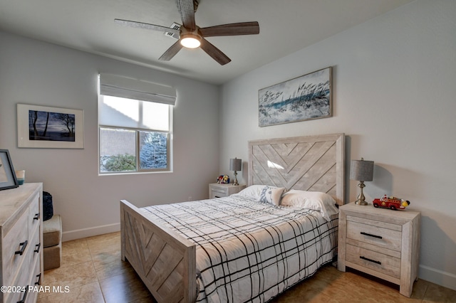 tiled bedroom featuring ceiling fan