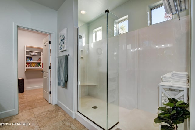 bathroom with tile patterned flooring and walk in shower