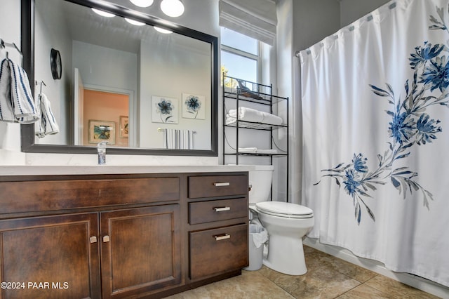 bathroom with tile patterned floors, vanity, and toilet